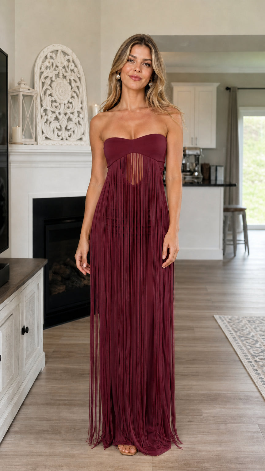 Model wearing burgundy strapless fringe maxi dress