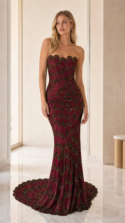 Model wearing burgundy sequin strapless mermaid evening gown