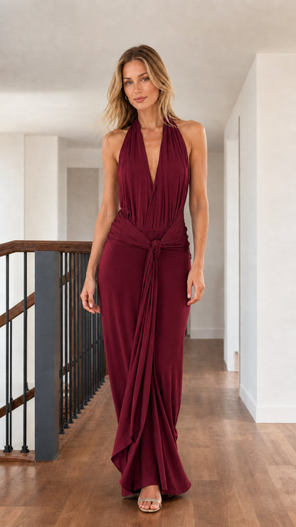 Front full view of woman wearing burgundy halter draped floor-length maxi dress