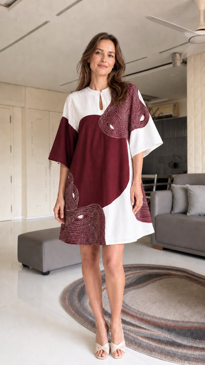 Model wearing burgundy and white shift dress