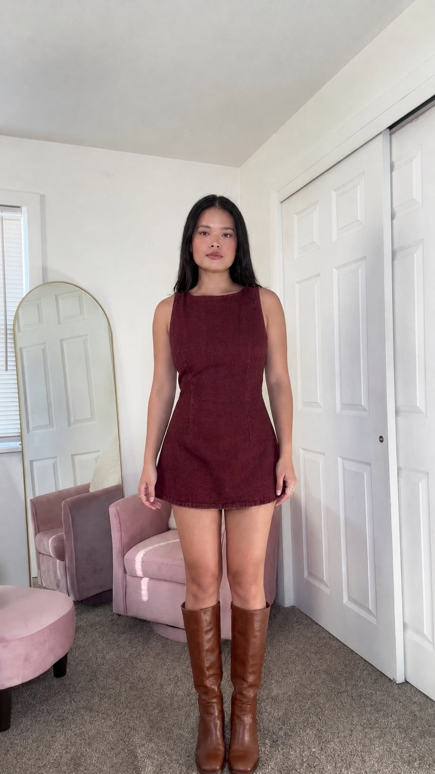 Front view of woman wearing burgundy denim mini dress