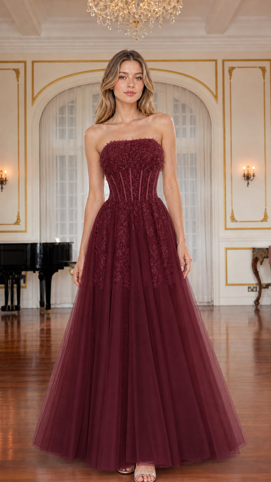 Model wearing burgundy red strapless corset tulle evening gown