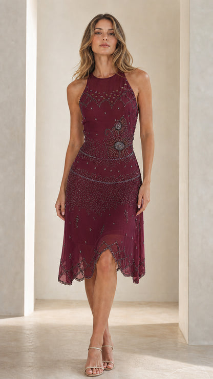 Front view of model in burgundy embellished halter midi dress