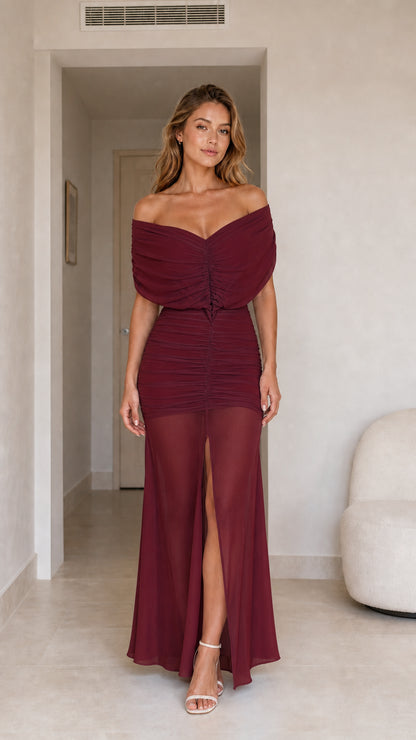 Model wearing burgundy off-shoulder ruched maxi dress