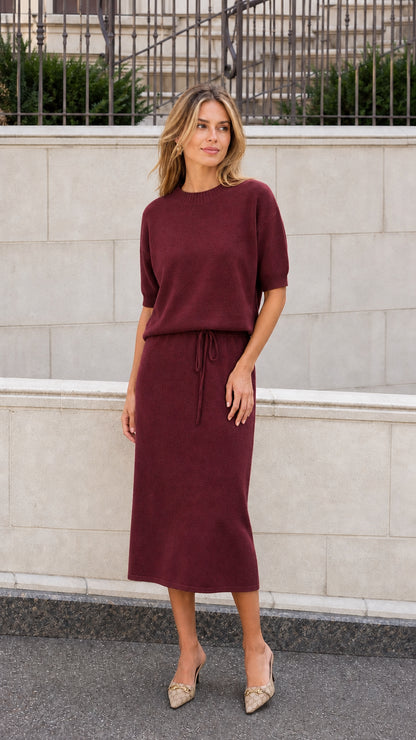 Burgundy short sleeve knit midi dress with drawstring waist shown on a model