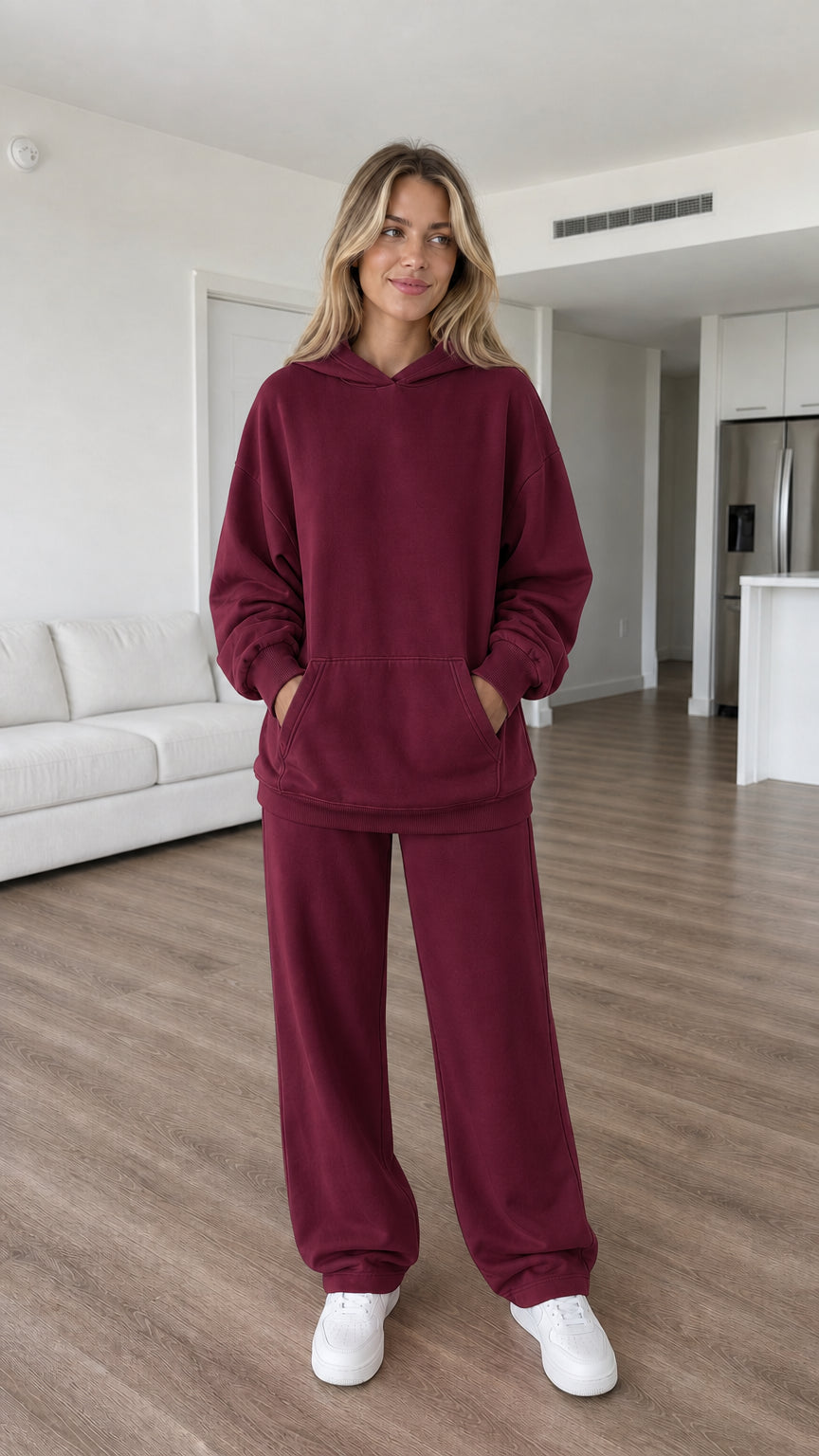 Model wearing burgundy oversized hoodie and sweatpants set