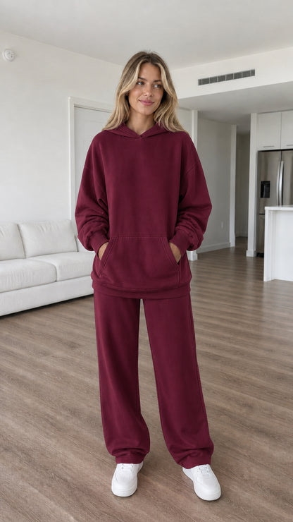 Model wearing burgundy oversized hoodie and sweatpants set