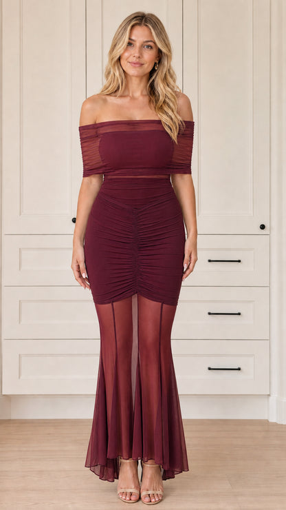 Front view of woman wearing off-the-shoulder ruched mesh mermaid dress in burgundy