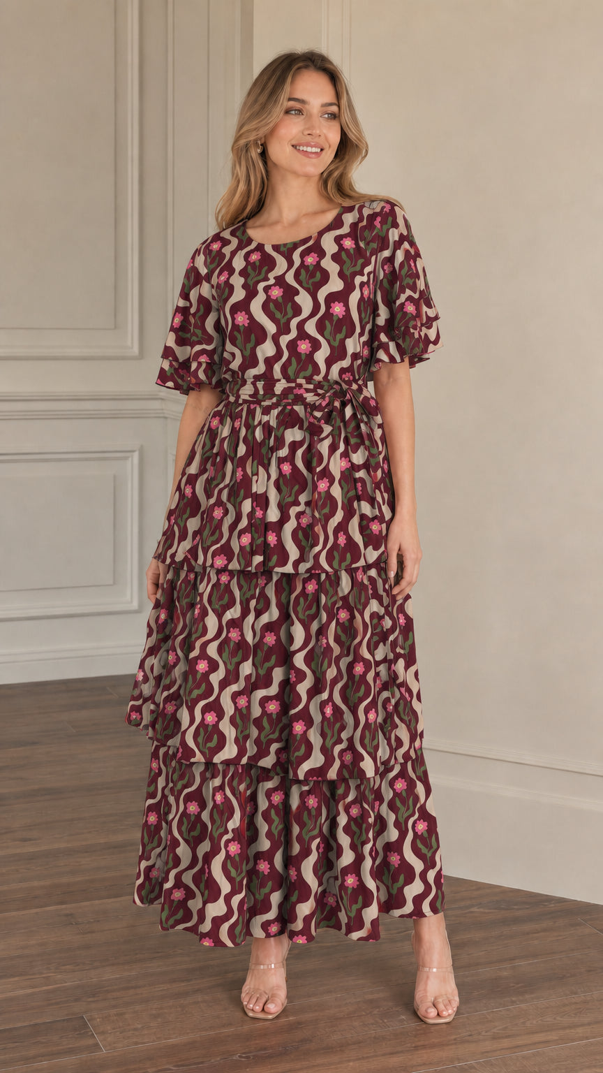 Front view of model wearing burgundy floral wave print tiered maxi dress