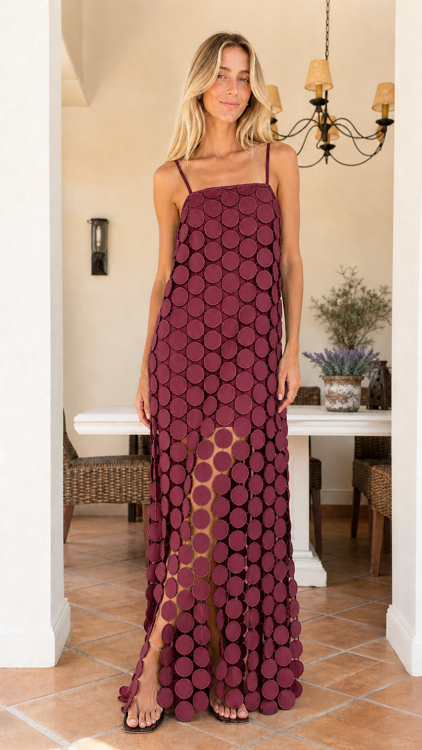 Front view of woman wearing burgundy cutout circle maxi dress