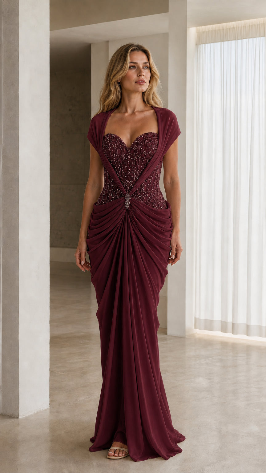 Front view of model in burgundy draped formal evening dress with beaded bodice