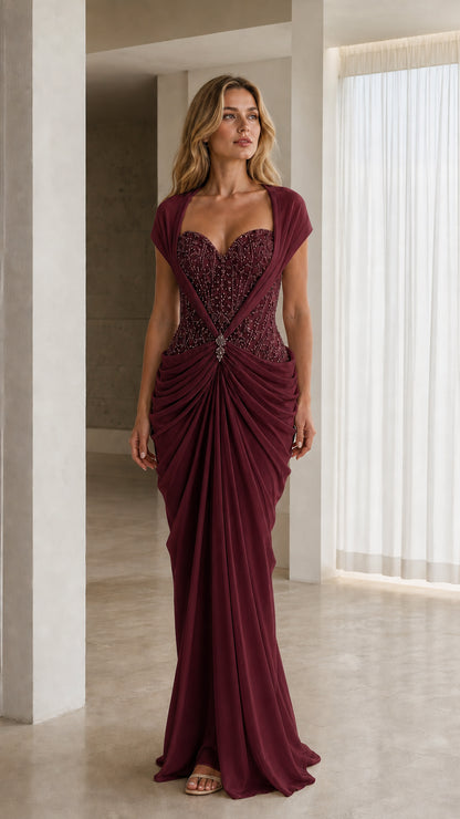 Front view of model in burgundy draped formal evening dress with beaded bodice