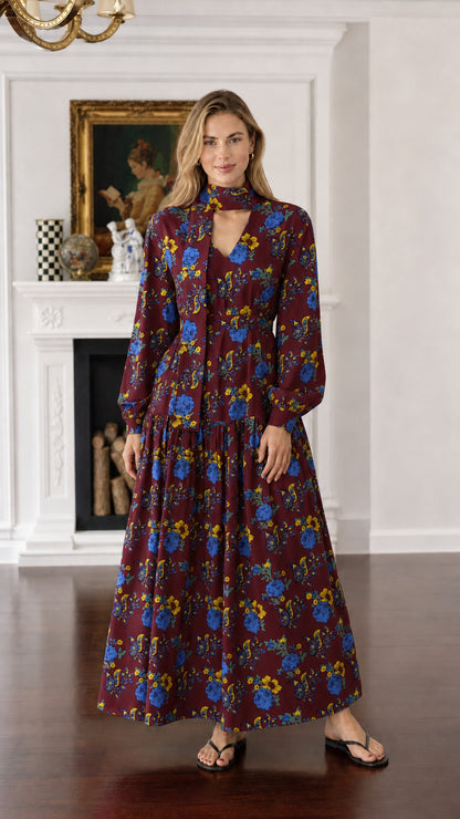 Front view of woman wearing burgundy floral long-sleeve maxi dress
