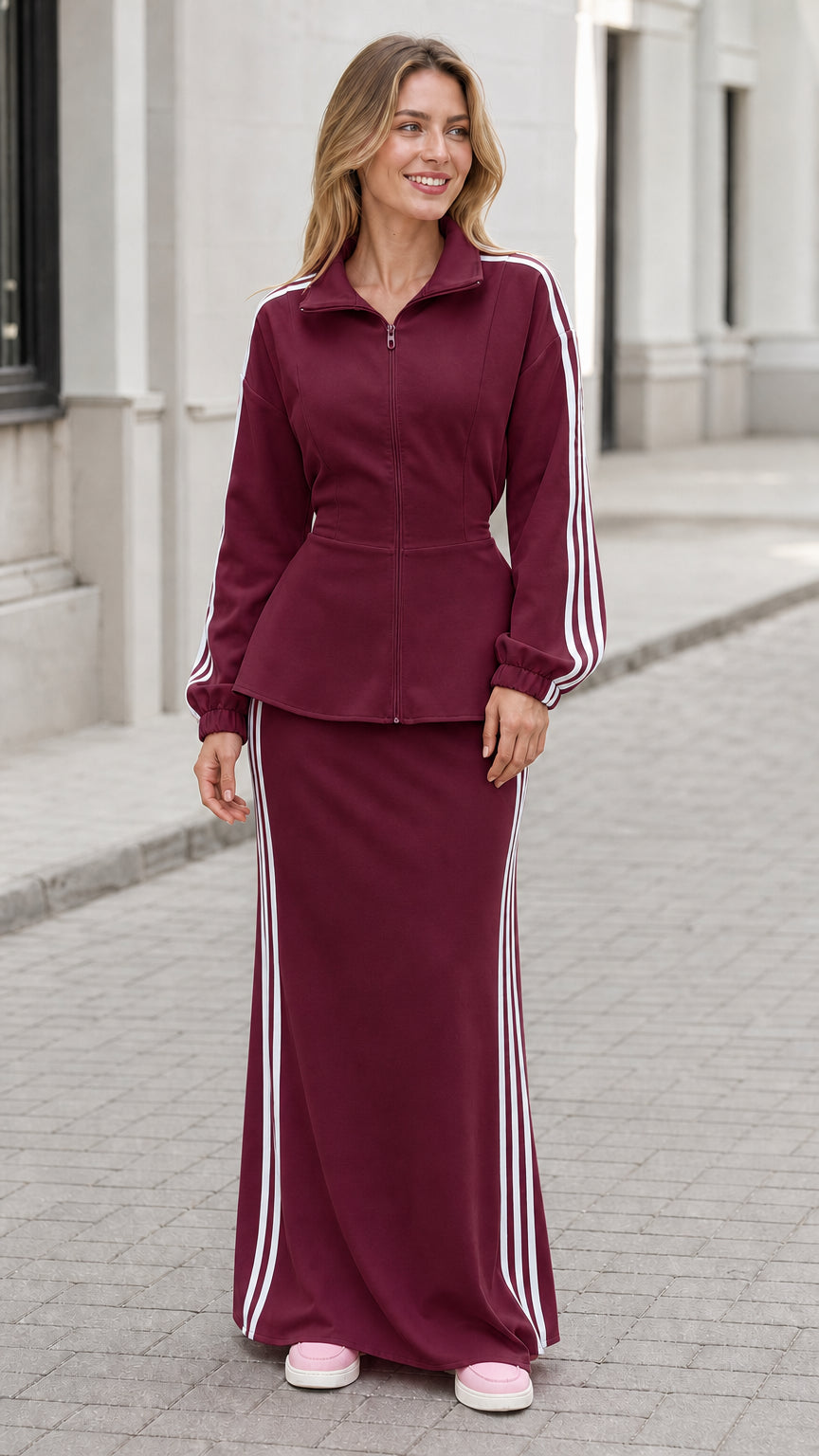Woman wearing burgundy wine-colored zip jacket and maxi skirt two-piece set