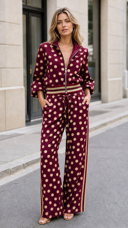 Full front view of woman wearing burgundy red polka dot two-piece tracksuit set