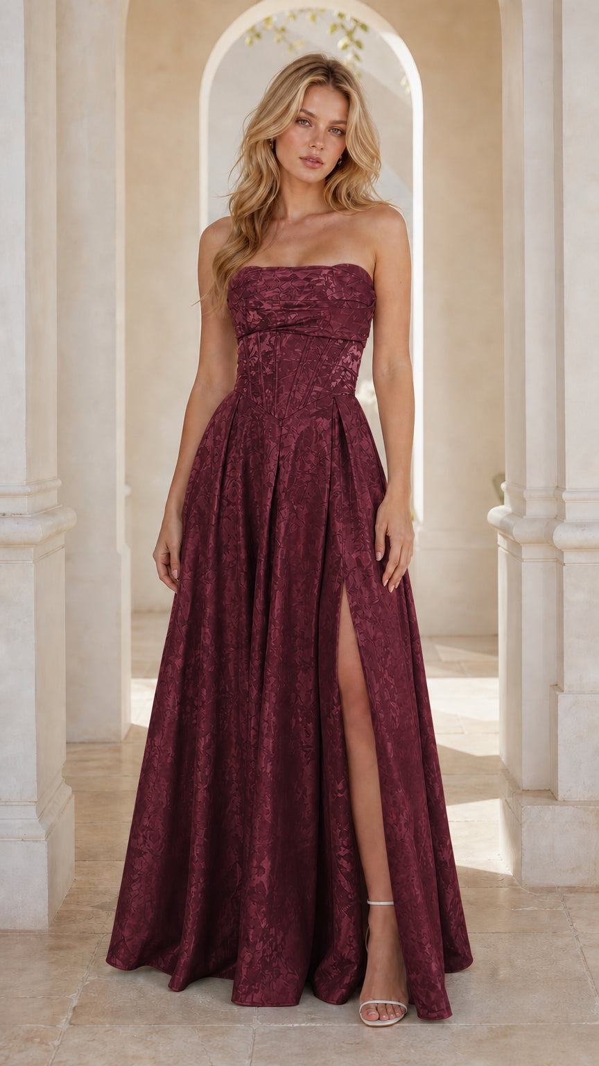 Model wearing burgundy wine strapless jacquard evening dress