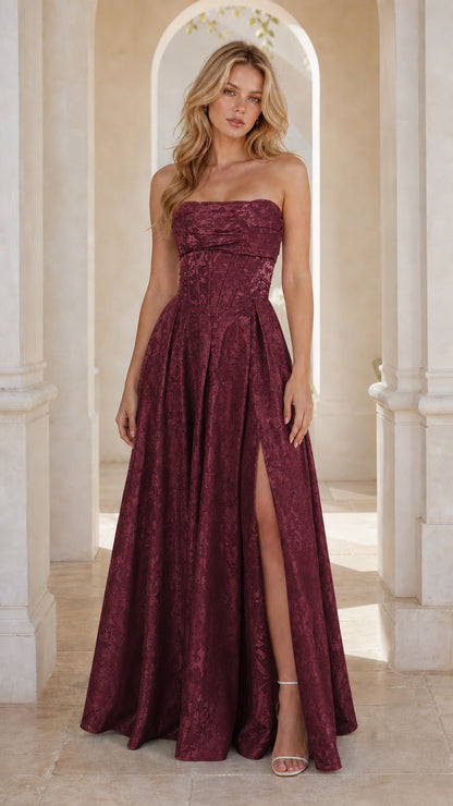 Model wearing burgundy wine strapless jacquard evening dress