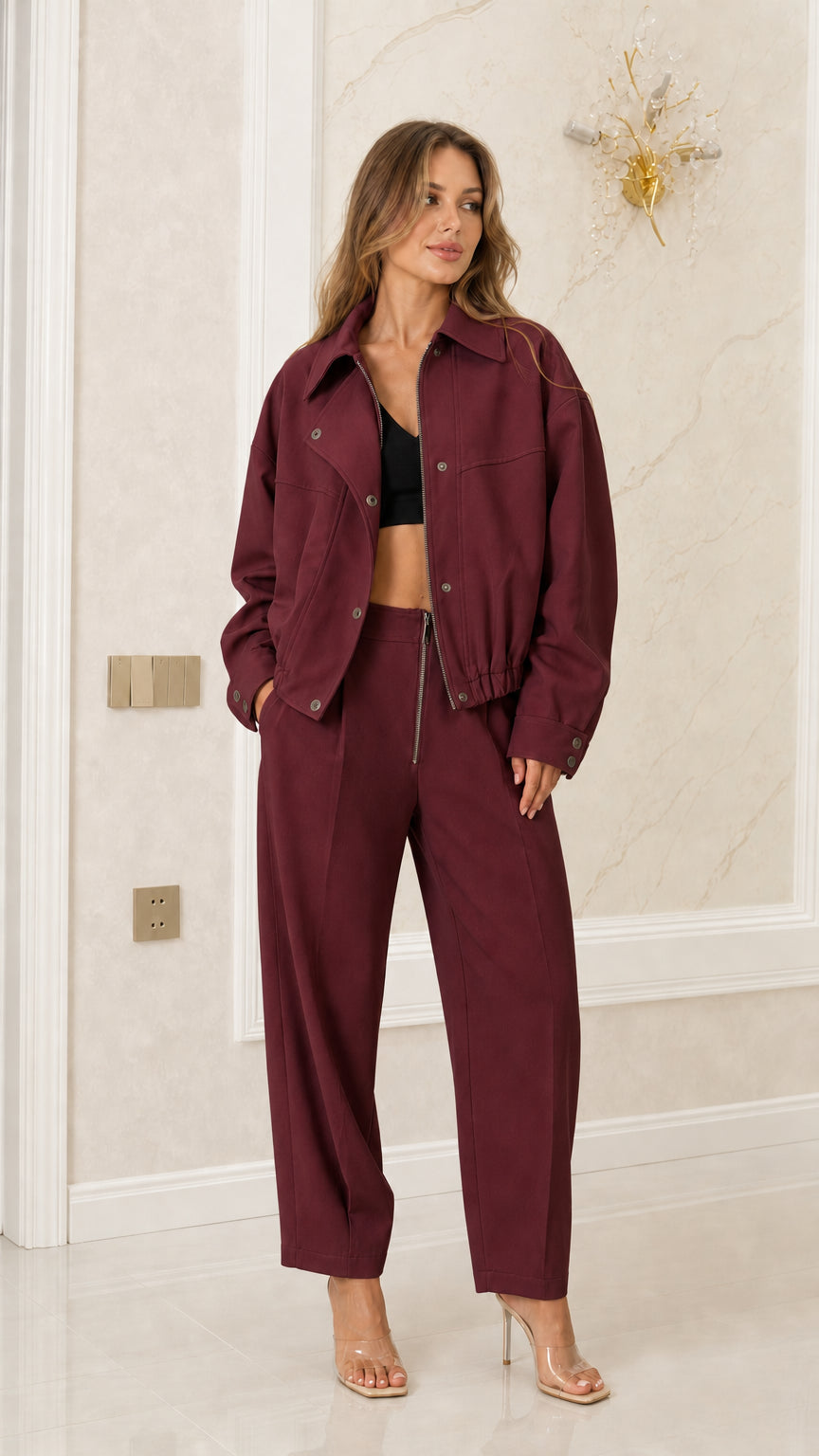 Model wearing Burgundy wine-colored bomber jacket and high-waist pants set