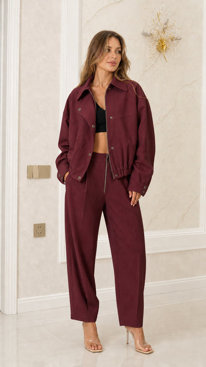Model wearing Burgundy wine-colored bomber jacket and high-waist pants set