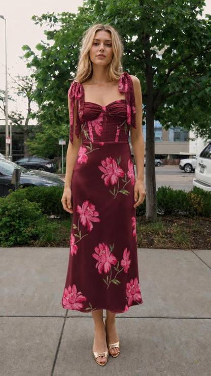 Front view of burgundy floral print tie-strap midi dress on model