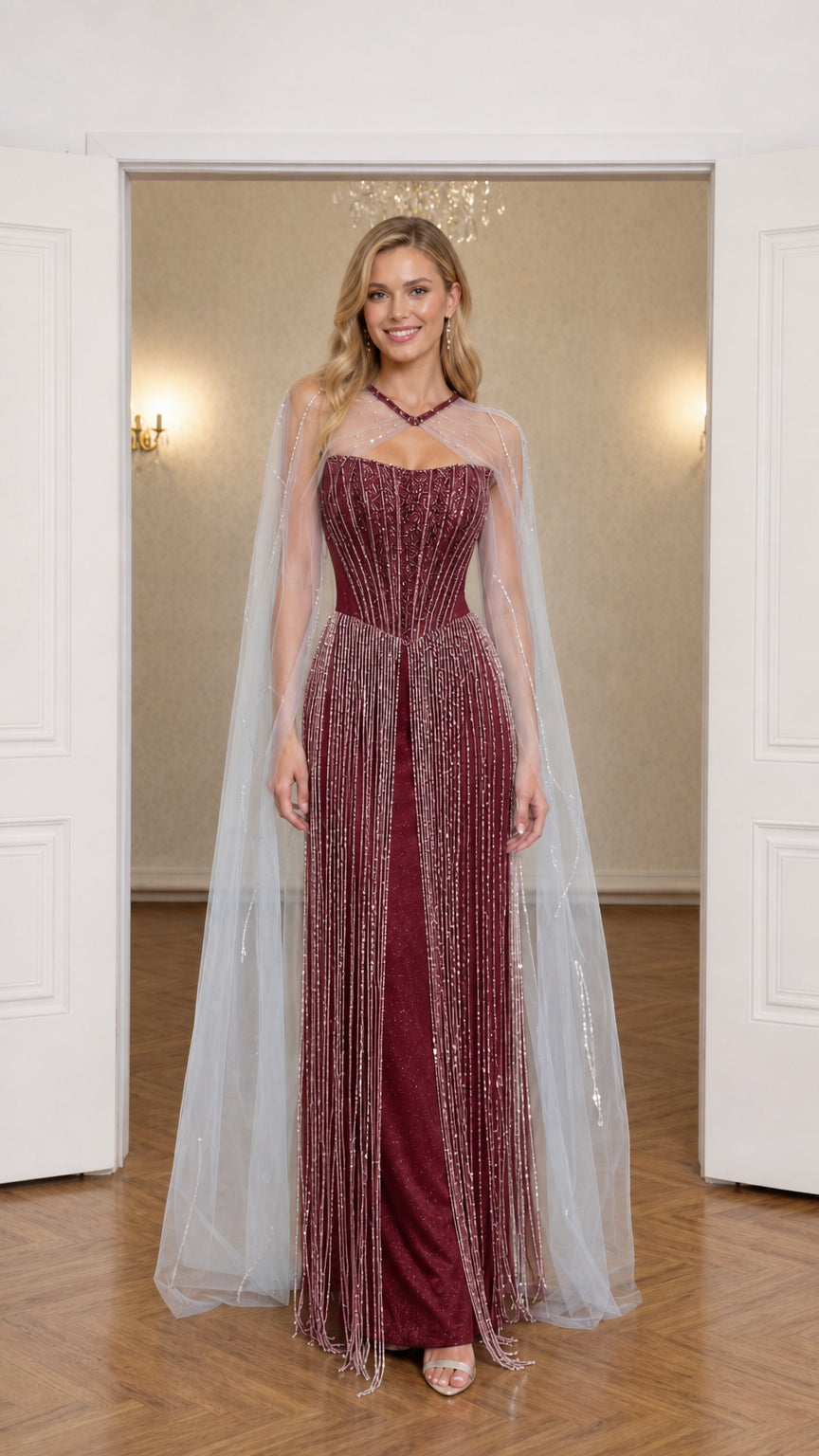 Front view of burgundy red beaded corset formal gown with sheer cape