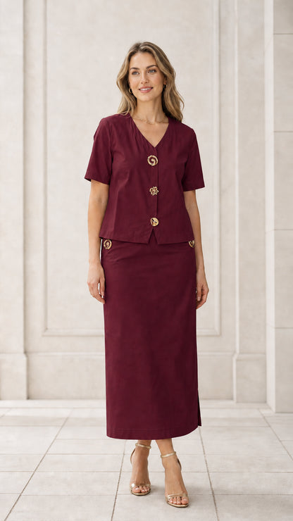 Front full view of woman wearing burgundy short sleeve blouse and maxi skirt set