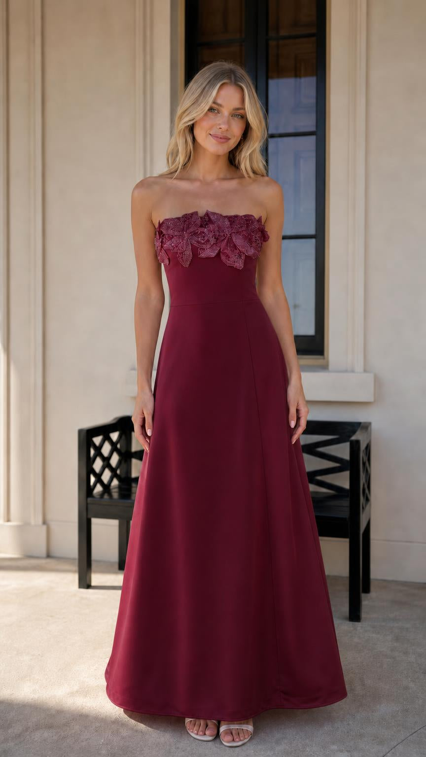 Model wearing burgundy evening dress with floral bodice