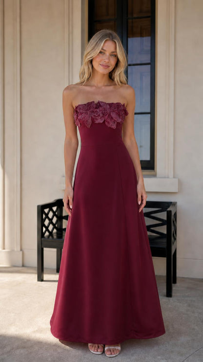 Model wearing burgundy evening dress with floral bodice