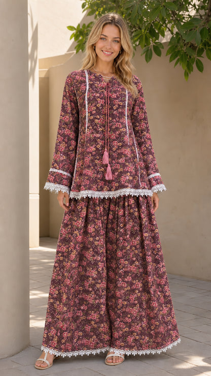 Model wearing burgundy floral matching tunic and pants set