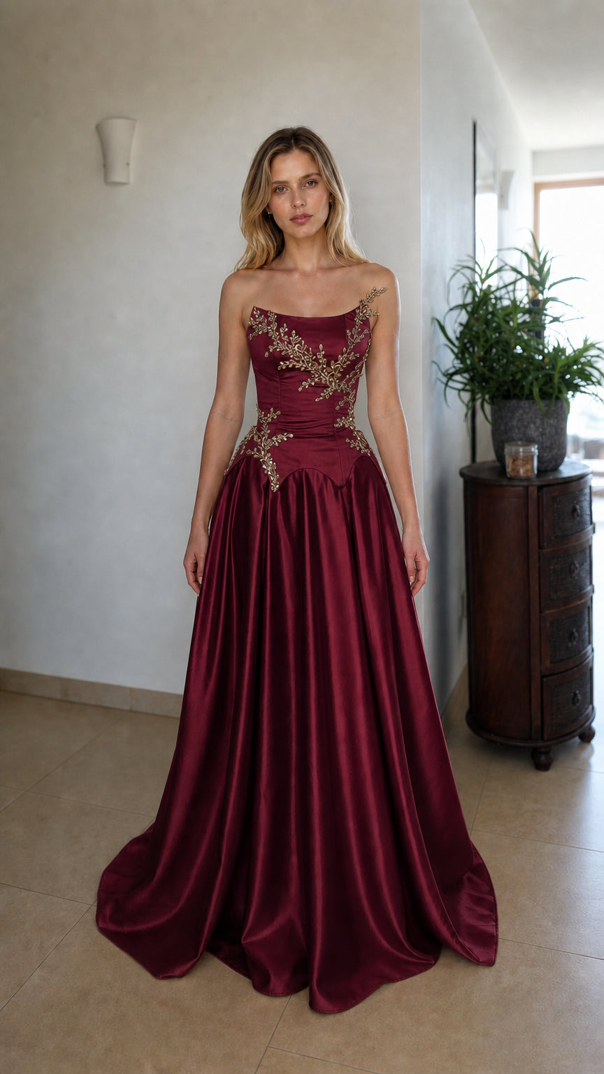 Front view of burgundy strapless beaded corset evening dress