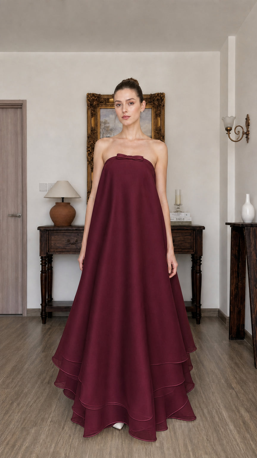 Woman wearing burgundy strapless tiered long dress