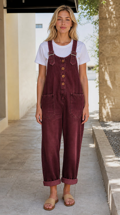 Front view of model wearing burgundy denim overalls