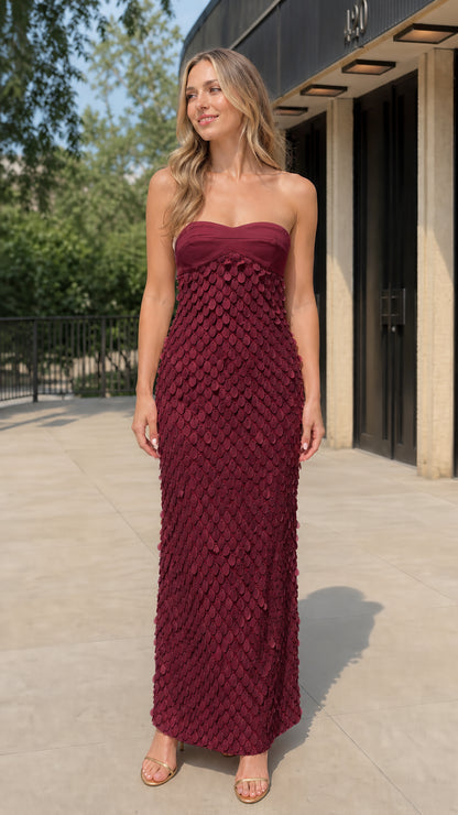 Model wearing burgundy sequin strapless maxi dress