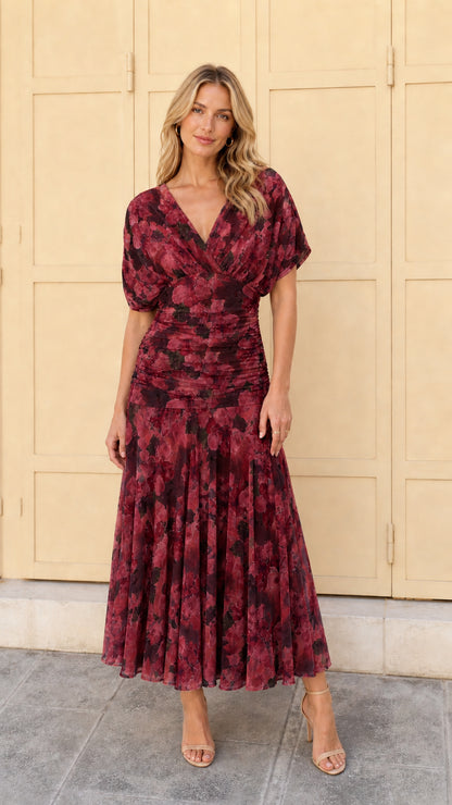 Woman wearing burgundy multi floral ruched midi dress
