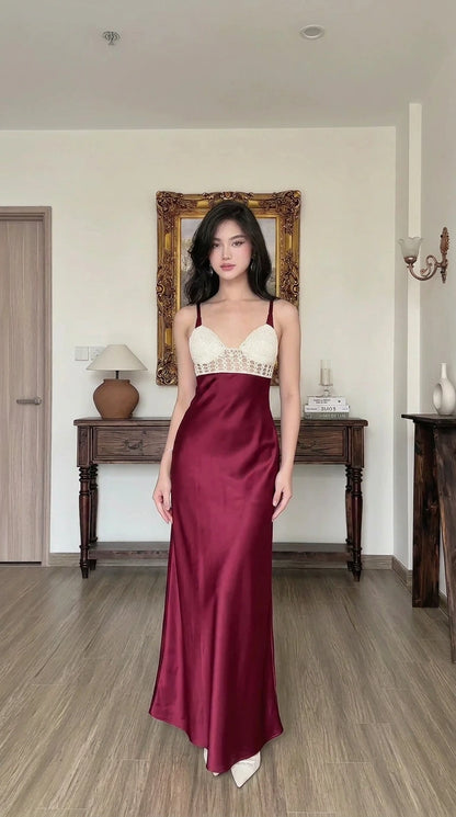 Woman wearing burgundy satin maxi slip dress with crochet contrast