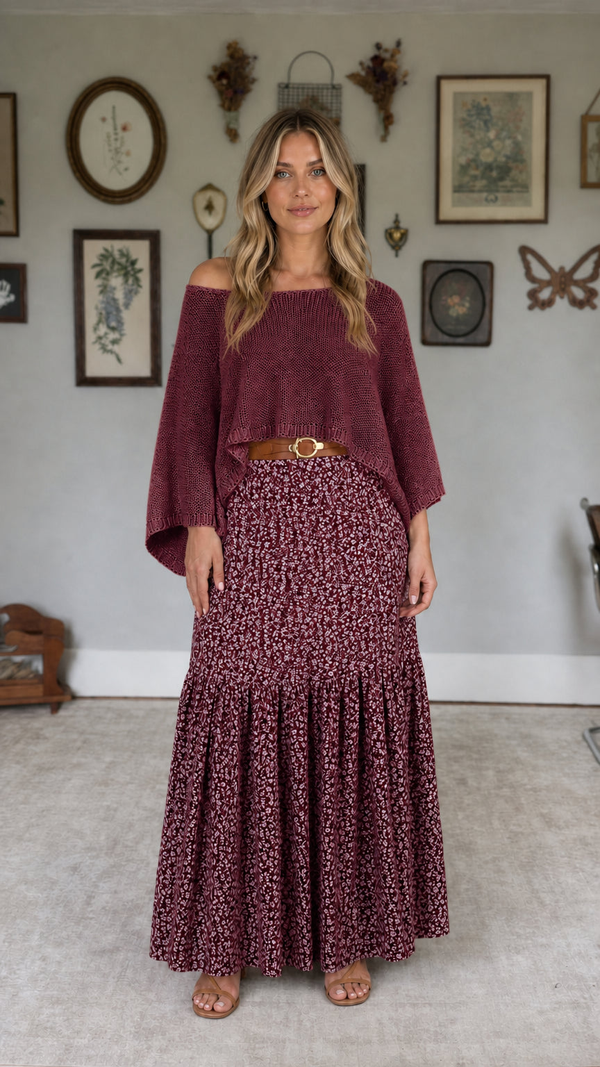 Model wearing burgundy off-the-shoulder knit top and burgundy floral maxi skirt set