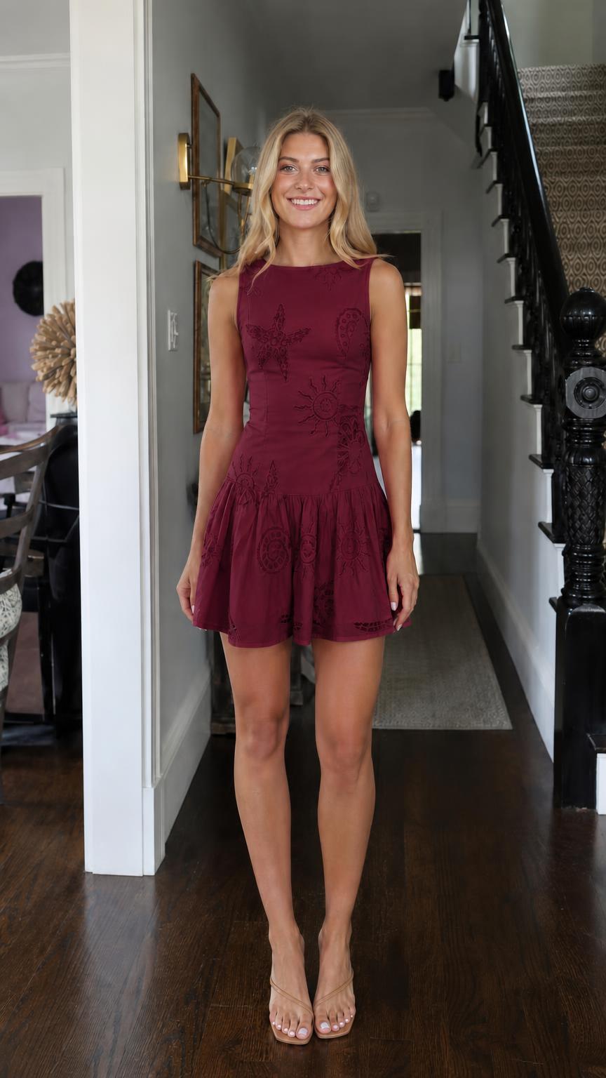Front view of model wearing burgundy sleeveless embroidered mini dress