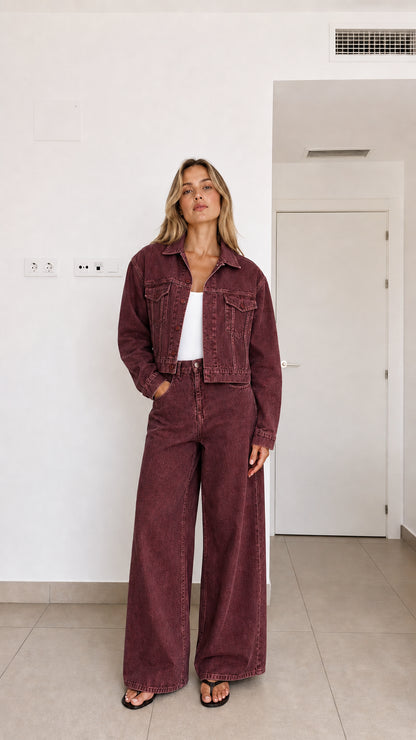 Woman wearing burgundy 2-piece cropped denim jacket and wide-leg trousers set