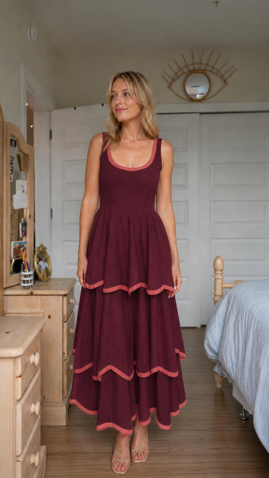 Front view of woman wearing burgundy tiered maxi dress