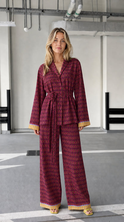 Woman wearing burgundy patterned two-piece lounge set