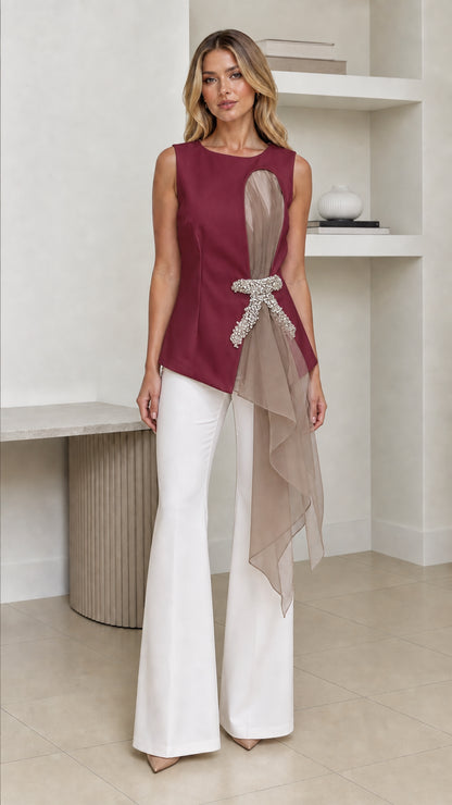 Front view of woman wearing burgundy color variant of the asymmetric top