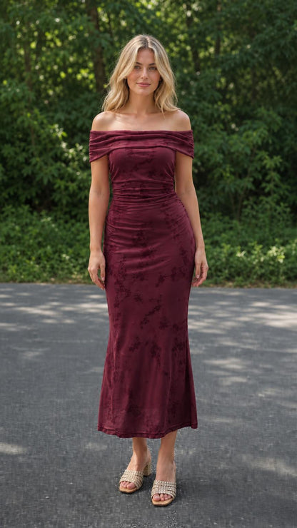 Model wearing burgundy off-the-shoulder ruched floral midi dress, front view
