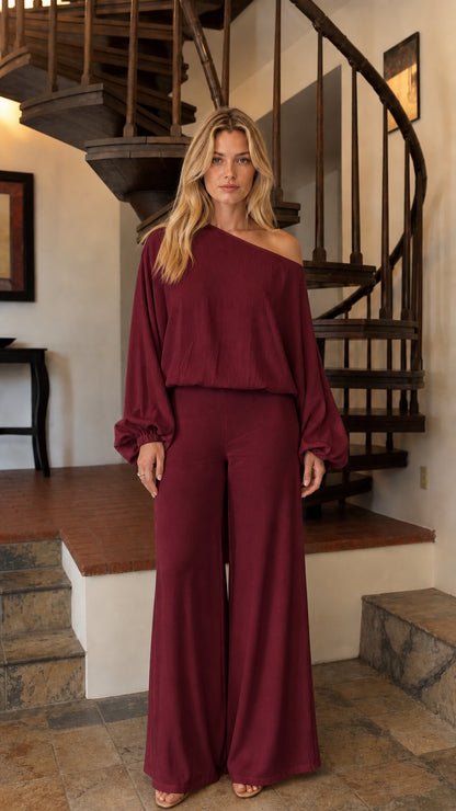 Front view of woman wearing burgundy one-shoulder pants set