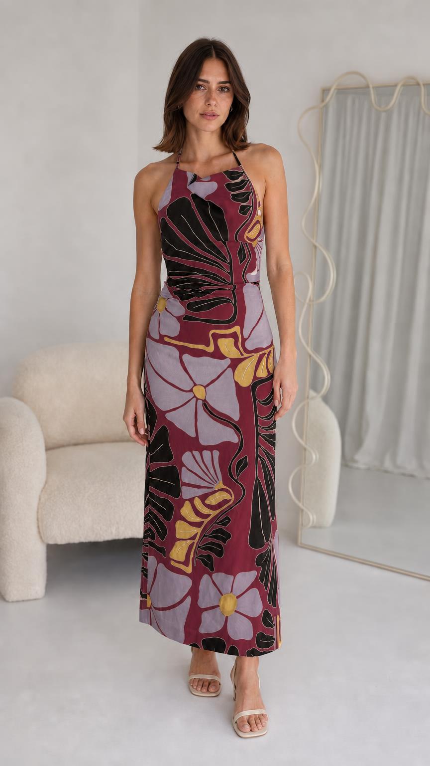 Front view of woman wearing burgundy floral halter maxi dress