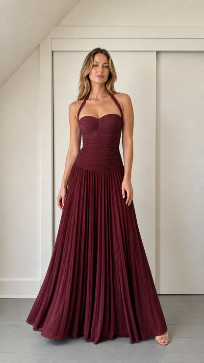 Model wearing burgundy ruched halter maxi dress