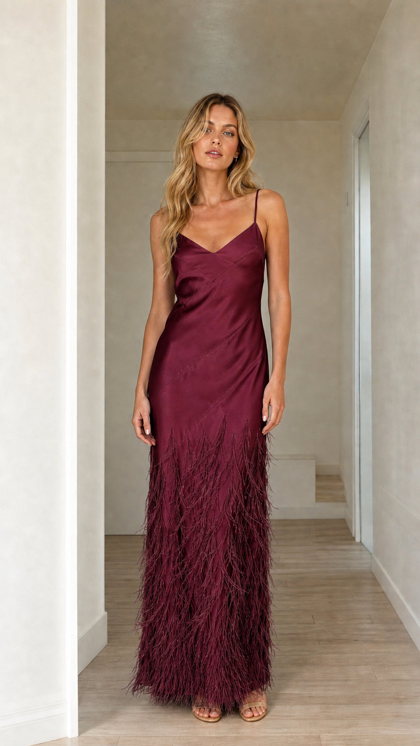 Woman wearing burgundy satin feather trim maxi slip dress