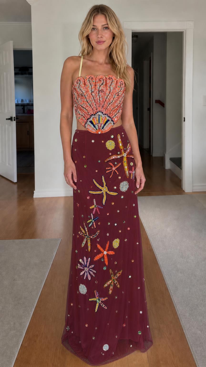 Model wearing burgundy color variant of beaded seashell two-piece dress