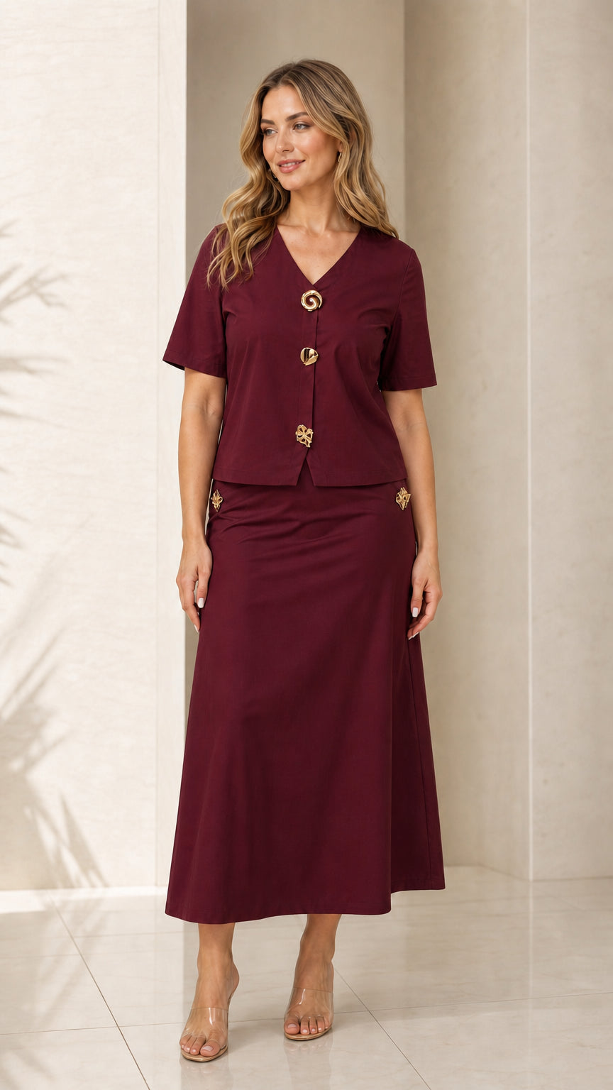 Front view of model wearing burgundy wine two-piece V-neck top and maxi skirt set