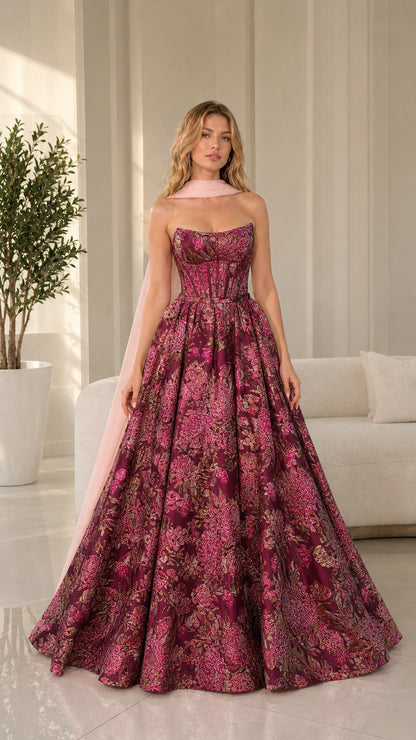 Model wearing burgundy floral brocade ball gown