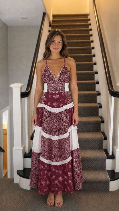 Front view of woman wearing burgundy floral tiered maxi dress